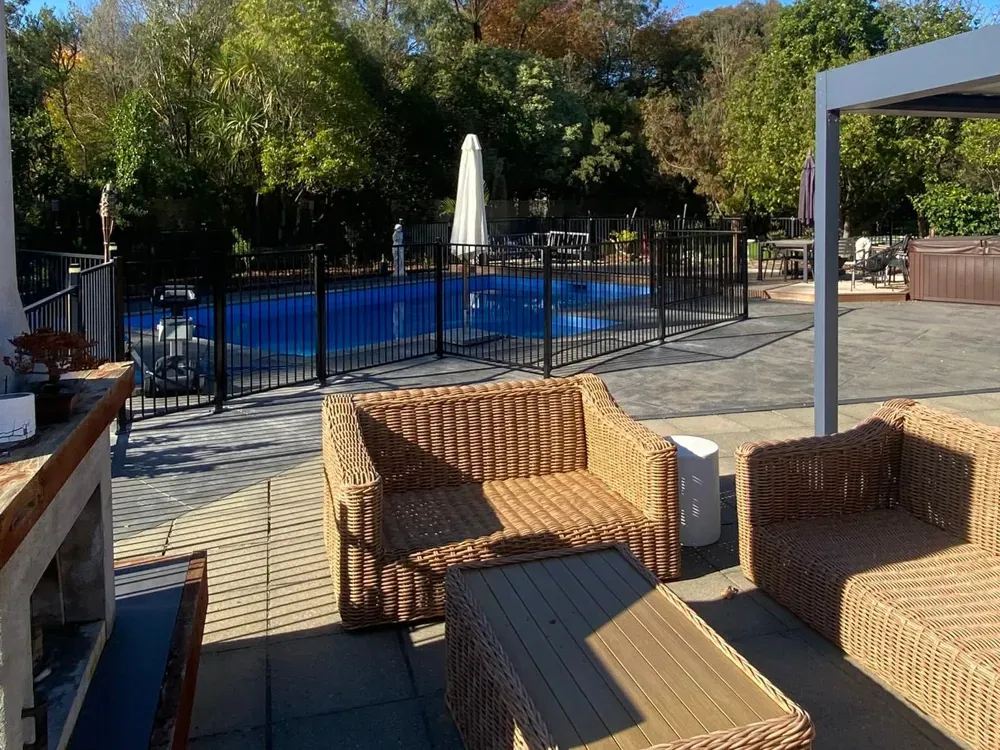 Black aluminium pool fence around a patio and swimming pool, Palmerston North