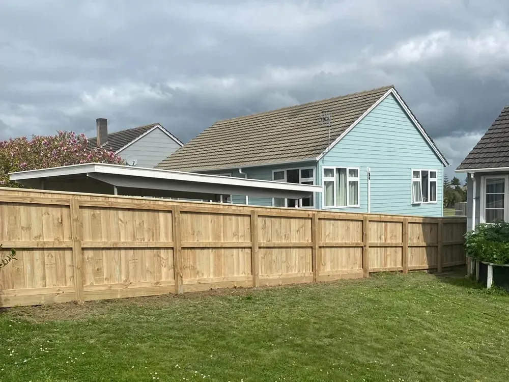 New timber paling fence across a lawn beside a Palmerston North home