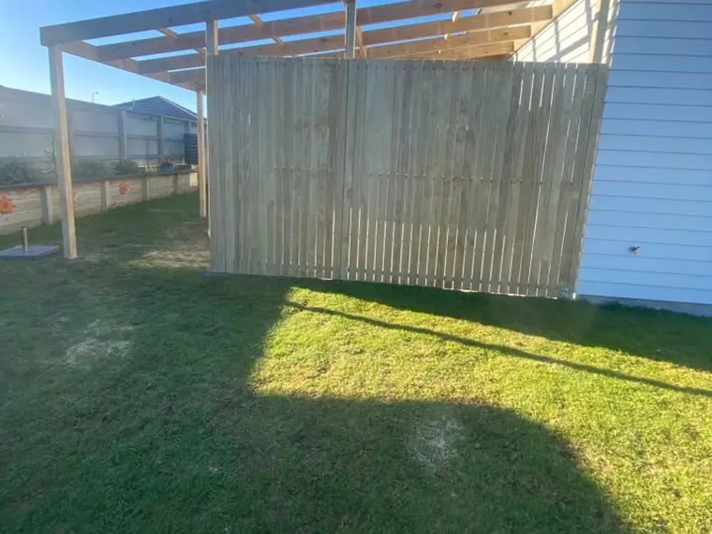 Timber privacy screen fence beside a new pergola