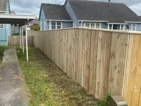 Timber paling fence beside a side path next to a house, Palmerston North