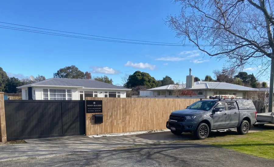 Rowdy Builders ute parked beside a newly built timber fence, Palmerston North